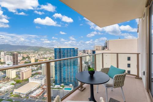 a balcony with a table and chairs and a view at Sky Ala Moana 4209 condo in Honolulu