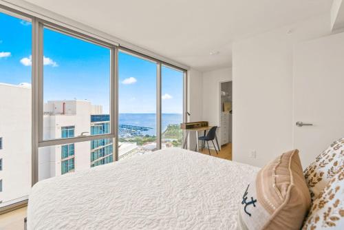 a bedroom with a bed and a large window at Sky Ala Moana 4209 condo in Honolulu