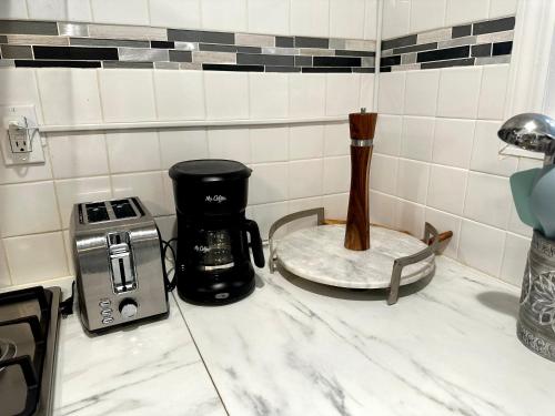 a kitchen counter with a coffee maker and a toaster at 2-A Diamond in Yonkers in Yonkers