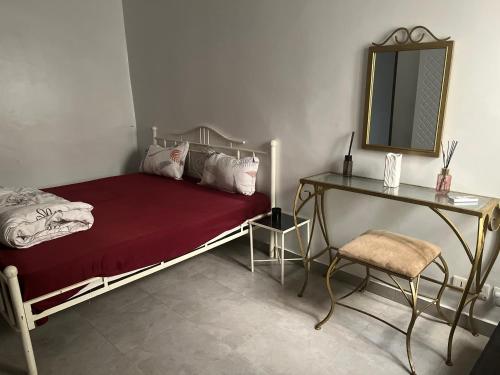 a bedroom with a bed with a mirror and a desk at Cosy appart F3 à liberté 6 extension in Dakar
