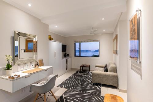 a living room with a couch and a chair at THEBLOEM Guest Suites by Knysna Paradise Collection in Knysna