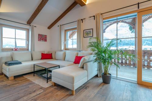 a living room with a couch and a table at Villa Elisabeth in Strobl