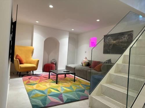 a living room with a couch and a table at Norwich city centre, Norfolk, free car parking. in Norwich