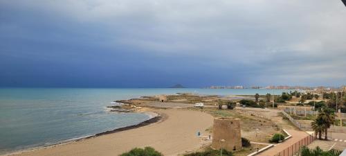 a view of a beach and the ocean at Beachfront Apartment La Manga in La Manga del Mar Menor