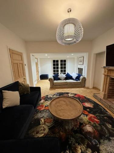 a living room with a couch and a table at Norwich city centre, Norfolk, free car parking. in Norwich