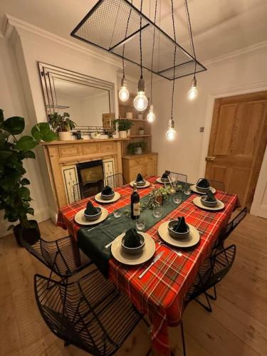 a dining room table with plates and hats on it at Norwich city centre, Norfolk, free car parking. in Norwich