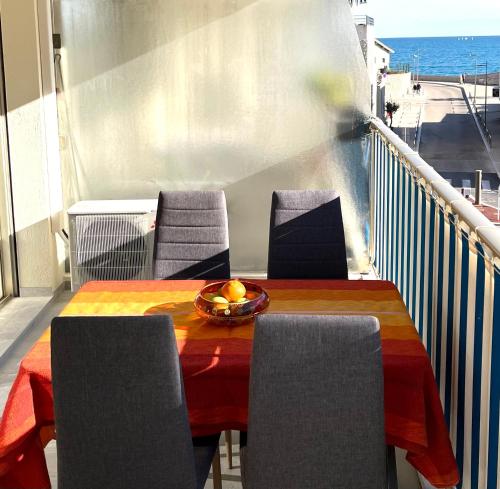 une table et des chaises sur un balcon avec l'océan dans l'établissement Antibes carré d'or Bastion Albert 1er Vue mer, à Antibes