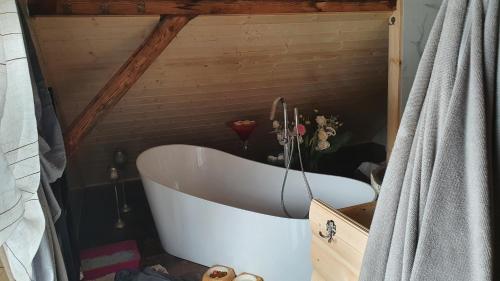 a bath tub in a bathroom with a wooden ceiling at Wellness-Beskydy in Prostřední Bečva