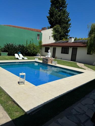 a swimming pool in front of a house at Like at Home Ezeiza in Ezeiza