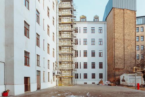 a tall white building with a scaffolding at Cosy Central Studio Apt. - Near Old Town in Riga