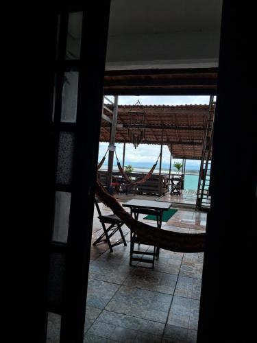 a view of a patio with a table and chairs at Pousada Marambaia Café in Barra de Guaratiba