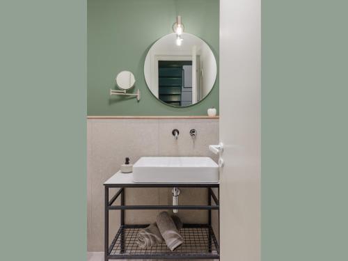 a bathroom with a sink and a mirror at Mystique Loft Ioannina in Ioannina