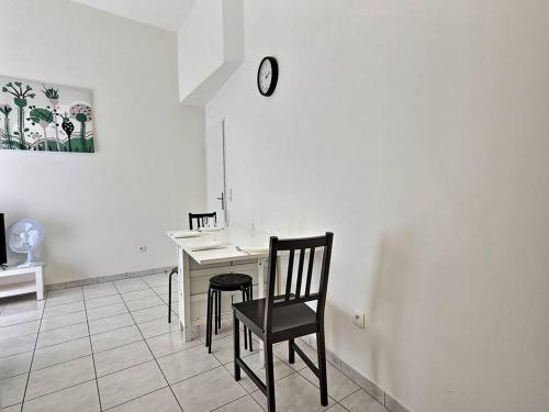 un bureau avec une chaise et un réveil sur un mur dans l'établissement Cocon de Champs *Disney*Paris*Wifi*, à Champs-sur-Marne