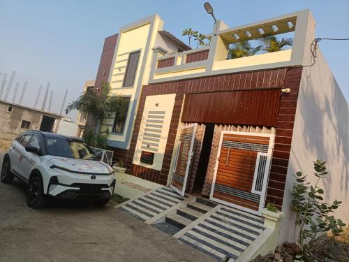a small car parked in front of a house at Adbhut Nivas (Home Stay) in Bhopal