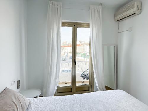a bedroom with a bed and a window at Casa ”Playa” in Santa Pola