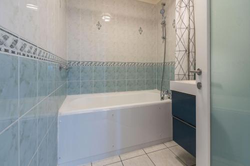 a bathroom with a bath tub and a shower at City View Apartments - Bow in London