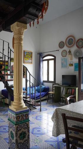 a living room with a column in the middle of a room at Casa Margherita in San Vito lo Capo