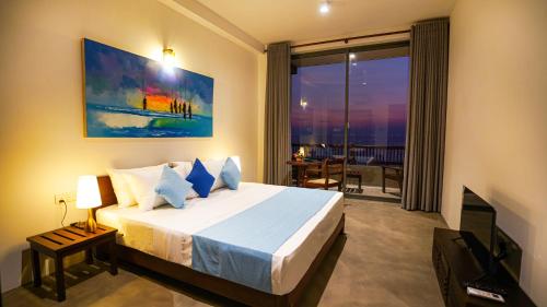 a bedroom with a king sized bed with a view at Beyond The Sea By Ceylonese in Ambalangoda