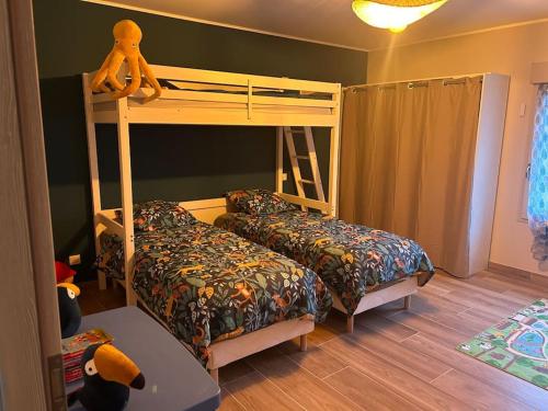 a bedroom with a bunk bed and two beds at Gite La Cuisance 