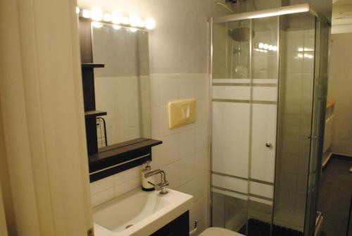 a bathroom with a toilet and a sink and a shower at Appartamento Arco della Pace in Milan