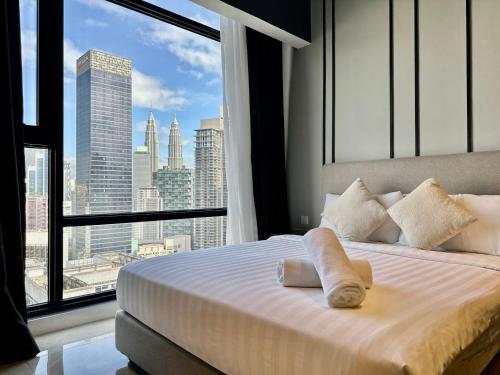 a bedroom with a bed with a view of a city at Axon Residence By Classy 1 minutes Pavilion in Kuala Lumpur