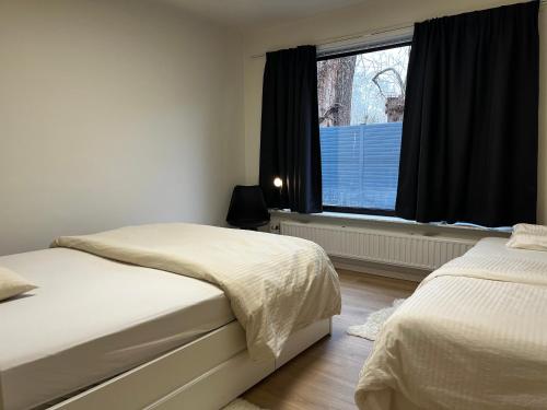a bedroom with two beds and a window at Budget Flex in Geel