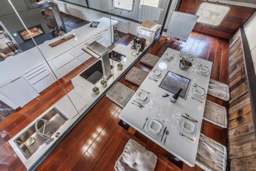 an overhead view of a kitchen with white appliances at Tabor 67 Luxury Houseboat in Ittre