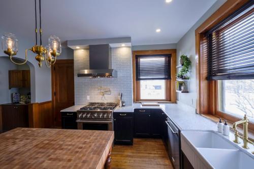 a kitchen with a stove and a sink at Squiers 1882 in Maquoketa