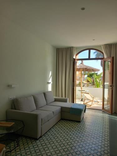 a living room with a couch and a patio at TORREMOCHA in Cabo de Palos