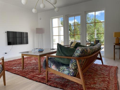 a living room with a couch and a table at Villa VitvikenA in Gotland Pool in Slite
