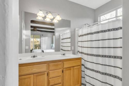 a bathroom with a sink and a shower curtain at Mediterranean Style Modern House in Sacramento
