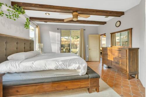 a bedroom with a bed and a ceiling fan at Mediterranean Style Modern House in Sacramento