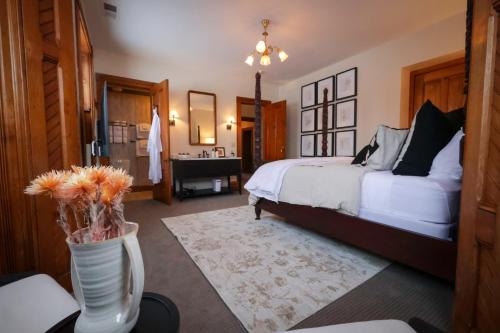 a bedroom with two beds and a vase with flowers at Squiers 1882 in Maquoketa