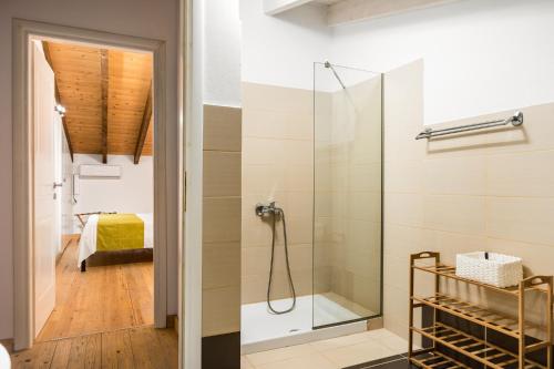 a bathroom with a shower with a glass door at Viros Holiday House in Virós