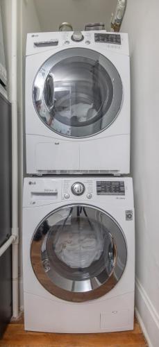 a washer and dryer sitting next to each other at 1 Bed Apt on Grand - Walk to 3 Breweries! in Des Moines