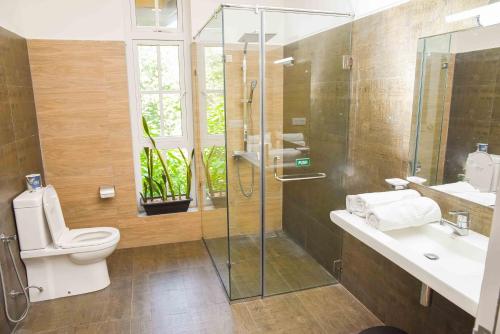 ein Bad mit einer Dusche, einem WC und einem Waschbecken in der Unterkunft Roberosia - Holiday Home in Kandy