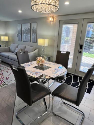 a dining room and living room with a table and chairs at Kelowna little Island near Downtown, lake, hospital and Okanagan Collage in Kelowna