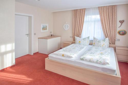 a bedroom with a large bed and a window at Dampfschiffhotel in Stadt Wehlen