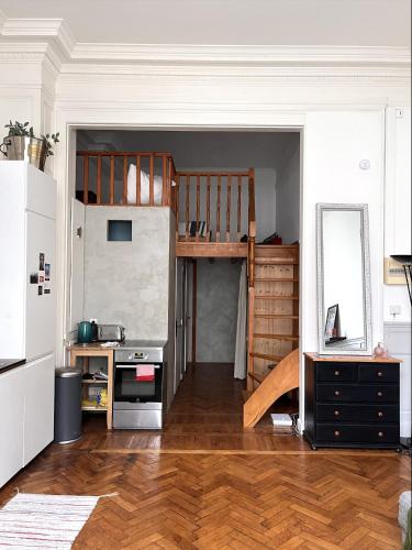 a living room with a loft bed and a kitchen at Appartement typique Lillois in Lille