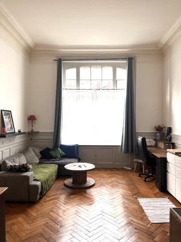 a living room with a couch and a table at Appartement typique Lillois in Lille