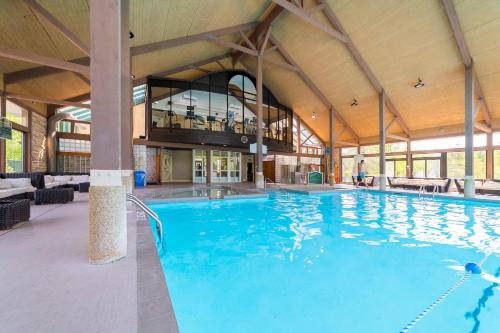 a large swimming pool in a large building at Horseshoe Valley Suites - The Maple in Shanty Bay