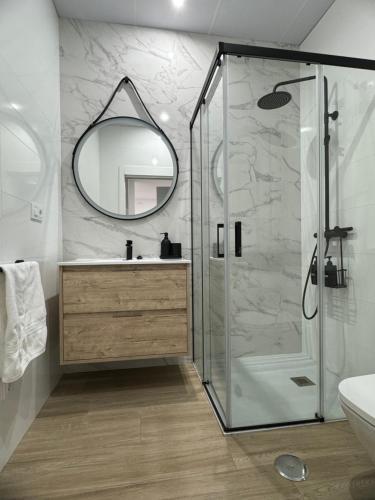 a bathroom with a shower and a sink and a mirror at Casa Luz in Montoro