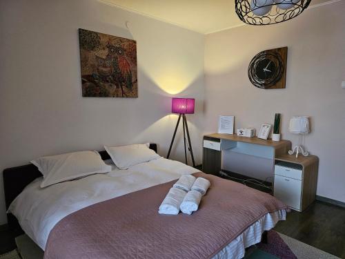a bedroom with a bed with a desk and a lamp at Stone Bridge Studio in Iaşi