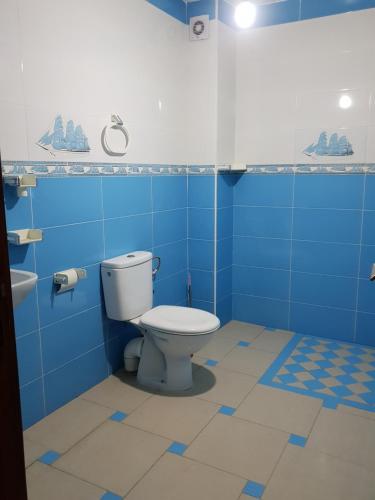 a blue bathroom with a toilet and a sink at Oualidia golden sand in Oualidia