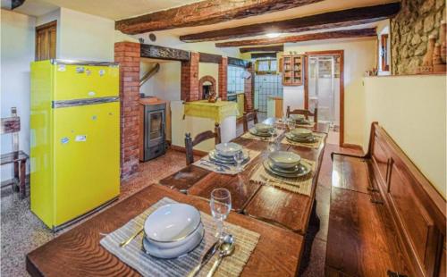 a kitchen with a wooden table and a yellow refrigerator at Antico Casale di Ferdinandi in Bibbiena