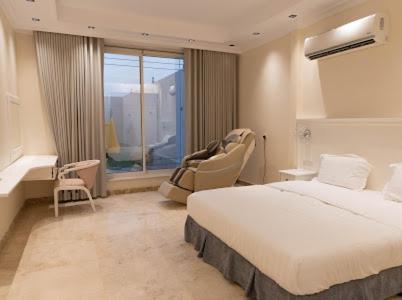 a bedroom with a large bed and a window at ملك فيلا in Al Madinah