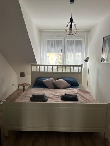 1 dormitorio con 1 cama con 2 toallas en Apartament Oksford 3 en Okszów