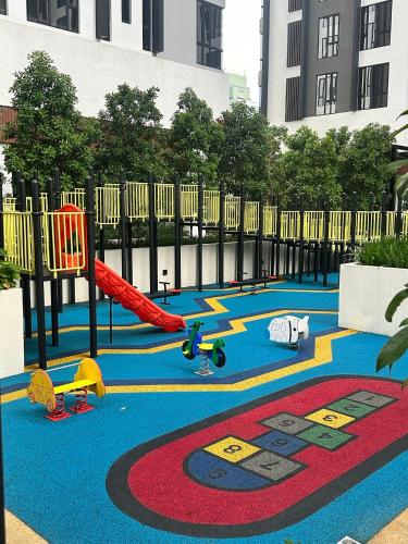 a playground with toys on a blue carpet at SENTRAL SUITES in Kuala Lumpur
