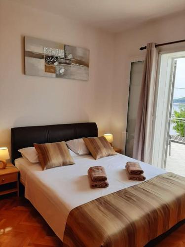 a bedroom with a large bed with two towels on it at Mediterranean Jewel in Blato