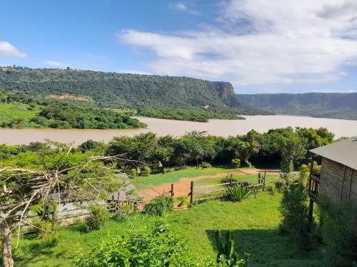 a house with a view of a river and a mountain at Entendeni Lodge SelfCatering in Inanda